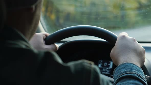 Male Hands on the Steering Wheel