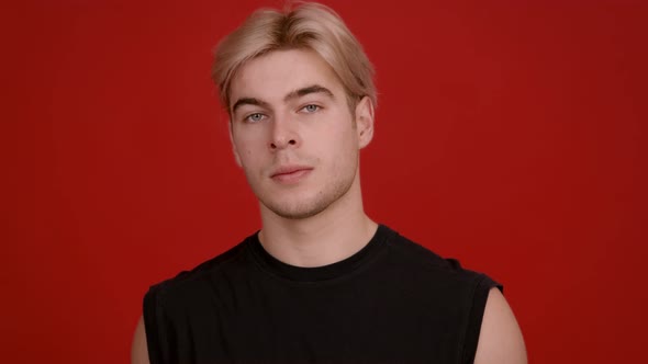 Studio Portrait of Handsome Blonde Guy Looking Seriously at Camera