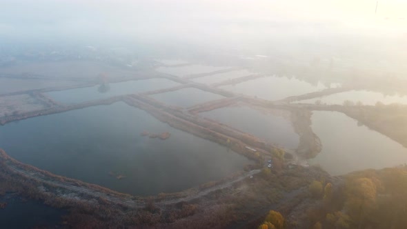 Aerial Drone View Flight Over Artificially Dug Ponds for Fish Farming Autumn