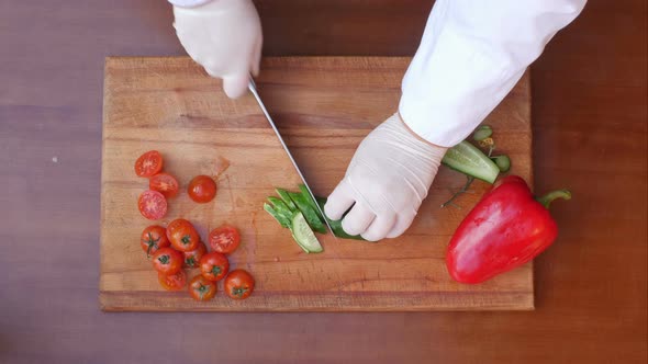 Cutting Cucumber on a Wooden Board