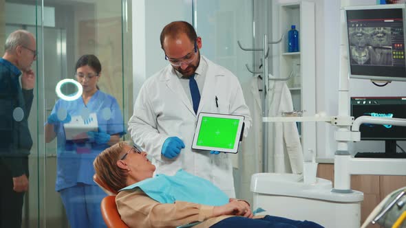 Dentist Pointing at Green Screen Display