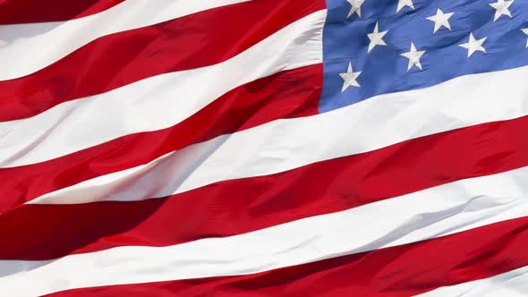 American flag waving in the wind on blue sky