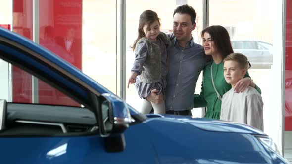 Mother Father and Child Buying Car at Dealership a New Family Auto