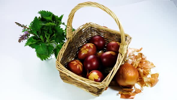 Naturally colored Easter eggs with onion skin and dried flowers. Eggs in the basket.