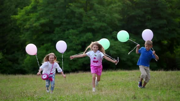 Group of Happy Children Playfully Running with Multicolored Balloons