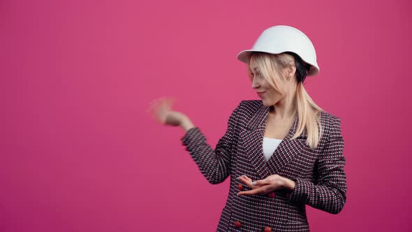 Beautiful Blonde with an Engineer's Helmet on Her Head Recommends on the Left Side at the End She