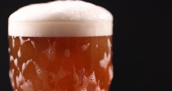 Mug of Beer with Glass Flowing Foam on Dark Background Slow Motion  Movie