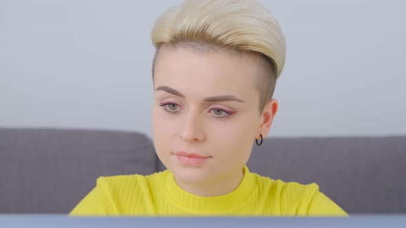 Young woman working on notebook computer at home on lockdown in 4k stock footage