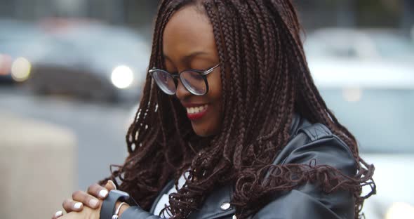 Close Up of Afroamerican Woman Using Smartwatch Standing Outdoors