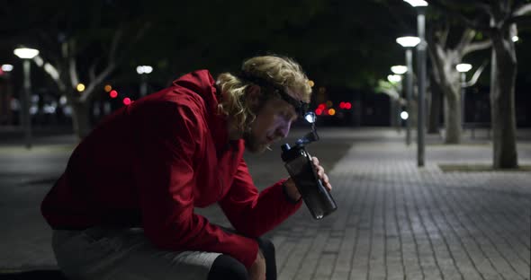 Sporty Caucasian man drinking water