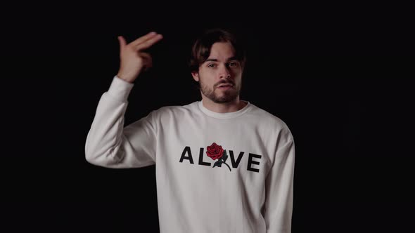 Trendy Young Man pointing finger gun at head, wide, black background