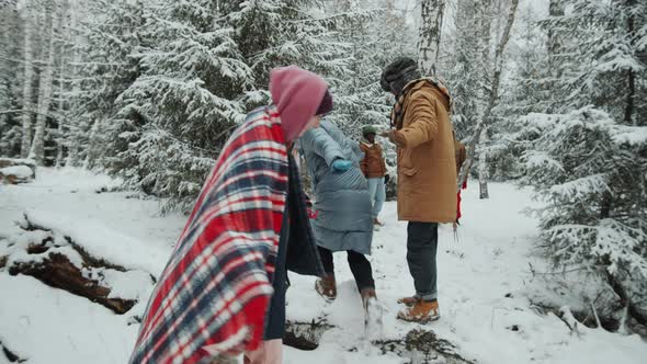 Friends Enjoying Winter Walk in Woods