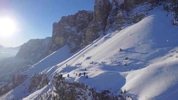 Flight through snowy landscape, Dolomites at sunrise, Italy