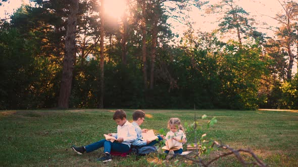 Student Sit on Green Meadow During School Break