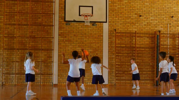 Schoolkids practicing basketball in basketball court at school 4k