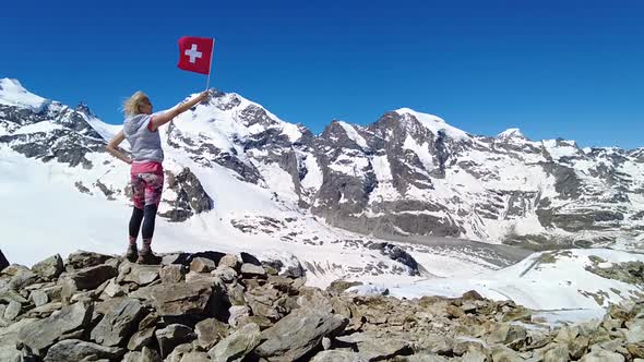 Girl on Diavolezza with Swiss Flag