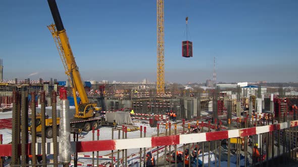 Tower Crane Transports Materials Along Construction Site