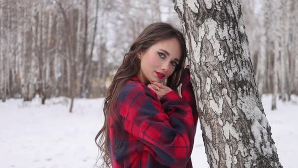 Woman with Red Lips in Winter Forest