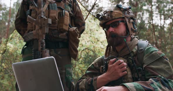 Portrait of Bearded Commander in a Military Uniform in a Tactical Vest with a Helmet on His Head