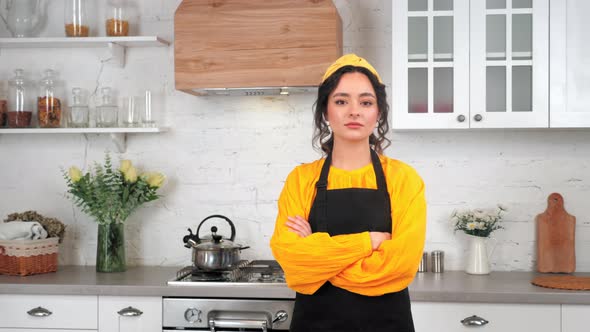 Portrait Serious Housewife Crossing Hands Looking Camera in Home Modern Kitchen