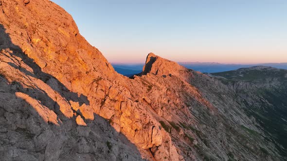 Dolomites mountains peaks with a hiking path on a summer sunrise