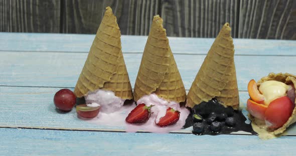 Sweet Melted Ice Cream Balls in a Waffle Cone. Different Berries and Fruits