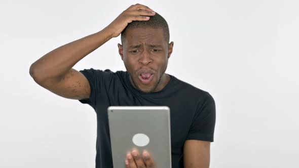 Young African Man Reacting to Loss on Tablet on White Background