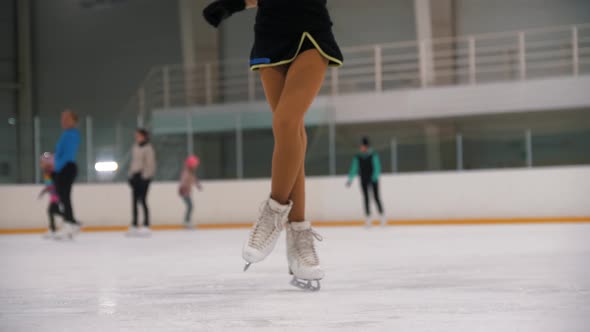 A Little Girl Training Her Figure Ice Skating on the Public Rink  Spinning on the Spot