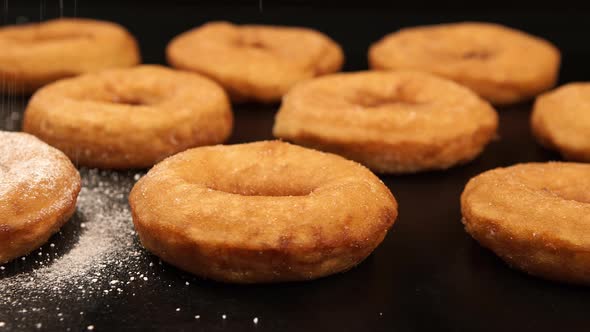 A sugar powder falling on a doughnuts