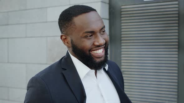 African Businessman Walking on City Street. Smiling Business Man Going Outdoors