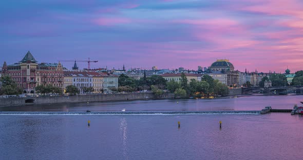 time lapse from Charles bridge on the Vltava River boats traffic during dusk with purple sky