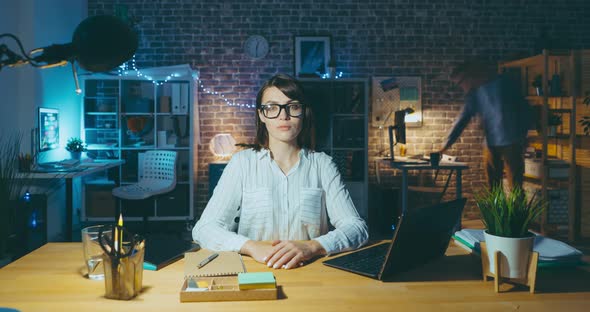 Time Lapse Portrait of Attractive Girl Office Worker Sitting at Desk at Night