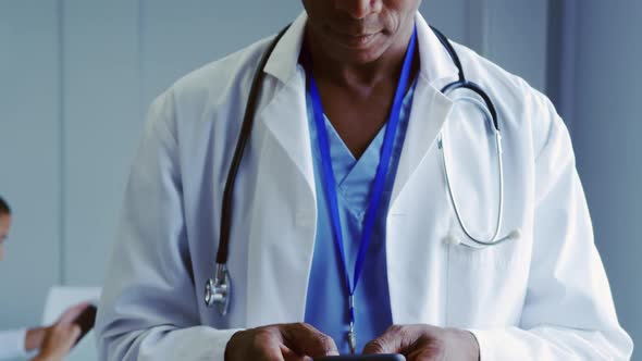 Close-up of African American male doctor using mobile phone in hospital 4k