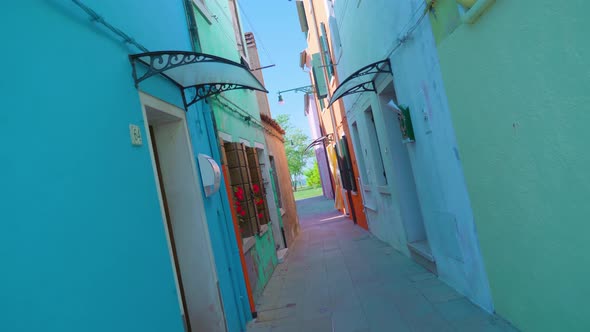 Narrow Street Between Colorful Houses in Burano on Sunny Day