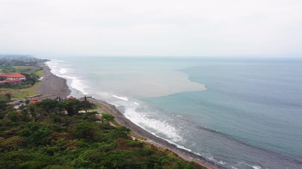 Black Sand Beach in Gray Foggy Day Mixing Water