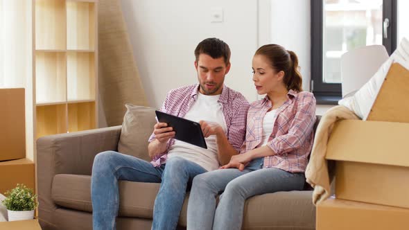 Happy Couple with Tablet Pc Computer at New Home