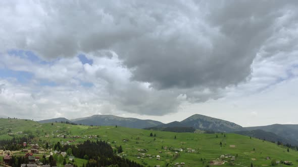 Aerial Drone Shot of Flying Up a Mountains Pine Trees and Mountain Ranges in the Background