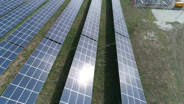 Drone If Flying Over the Long Rows of Solar Panels in the Field Modern Tech