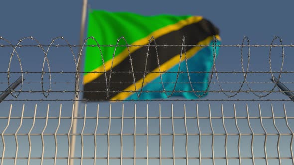 National Flag of Tanzania Behind Barbed Wire Fence