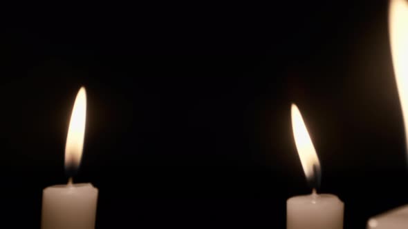 Burning Candle Against Black Background.