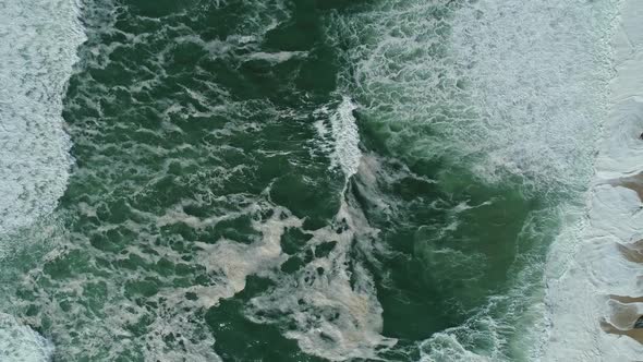 Aerial Top View on Ocean Waves and Sand Beach