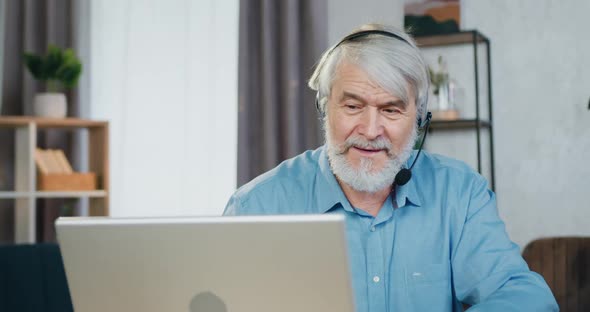 Positive Aged Man Talking with Relatives through Video Call