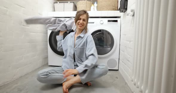 Angry Housewife Throwing Clothes at the Laundry