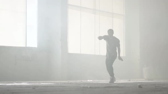 Skillful Young Great Hip-hop Dancer Performing in the Fog