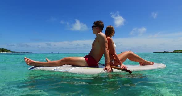 Young man and woman on romantic honeymoon enjoy luxury on beach on paradise white sand background