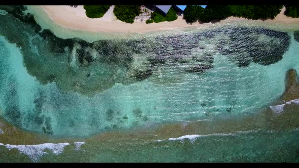 Aerial view panorama of tranquil resort beach journey by clear lagoon with white sandy background of