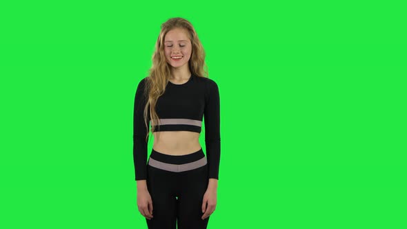 Blonde Girl Coquettishly Smiling While Looking at Camera. Green Screen