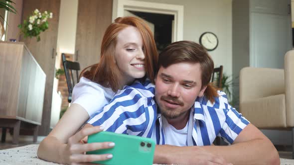 Couple Taking Picture Photo Using Smartphone at Home