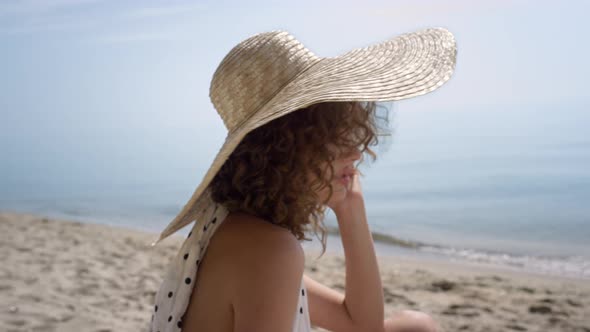 Seductive Woman Sitting Sand Beach Wearing Brimmed Hat Close Up