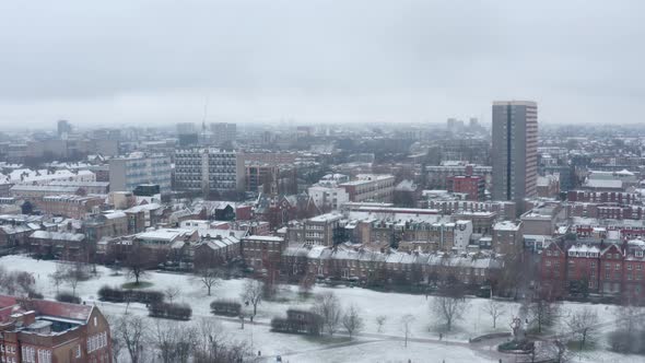 Aerial drone shot over snow covered London park East Bethnal Green Whitechapel